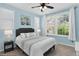 Cozy bedroom with white bedding, natural light, and a ceiling fan at 11208 W Ontario Ave, Littleton, CO 80127