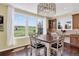 Bright breakfast nook with golf course views, hardwood floors, chandelier and lots of natural light at 11208 W Ontario Ave, Littleton, CO 80127