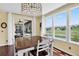 Bright breakfast nook with access to a screened in porch, golf course views and hardwood floors at 11208 W Ontario Ave, Littleton, CO 80127
