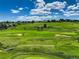 Scenic view of a lush green golf course with sand traps and manicured lawns under a blue sky at 11208 W Ontario Ave, Littleton, CO 80127