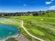 Picturesque golf course with lush greenery, a serene lake, and winding cart paths, offering a tranquil setting at 11208 W Ontario Ave, Littleton, CO 80127
