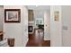 Hallway with view into the living area with fireplace and dark hardwood floors and neutral walls at 11208 W Ontario Ave, Littleton, CO 80127