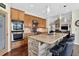 Modern kitchen with stainless steel appliances, stone island, and pendant lighting and hardwood flooring at 11208 W Ontario Ave, Littleton, CO 80127
