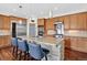 Gourmet kitchen with stainless steel appliances, large island, pendant lighting, hardwood flooring and breakfast bar at 11208 W Ontario Ave, Littleton, CO 80127