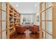 View of front living room with hardwood floors, built in book shelves and french doors at 11208 W Ontario Ave, Littleton, CO 80127