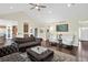 Bright living room with hardwood floors, vaulted ceiling, and oversized view windows to the golf course at 11208 W Ontario Ave, Littleton, CO 80127