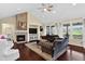 Living room featuring vaulted ceiling, stone fireplace, view windows, and dark hardwood flooring at 11208 W Ontario Ave, Littleton, CO 80127