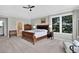 Spacious main bedroom with hardwood floors, ceiling fan, and windows at 11208 W Ontario Ave, Littleton, CO 80127