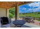 This covered patio offers golf course views, an outdoor dining set, and ample seating at 11208 W Ontario Ave, Littleton, CO 80127