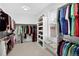 Well-organized walk-in closet with shelving, seating and a bright window at 11208 W Ontario Ave, Littleton, CO 80127