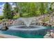 Beautiful water feature with a fountain and rock accents, set in a lush, landscaped yard with ducks at 11208 W Ontario Ave, Littleton, CO 80127