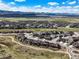 Wide aerial view of community, open space, and surrounding mountains at 8023 Gore Creek Ln, Littleton, CO 80125