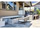 Inviting patio space with a modern fire feature, comfortable seating, and a view of the beautifully landscaped backyard at 8023 Gore Creek Ln, Littleton, CO 80125