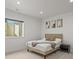 Bright bedroom with a tan bed frame, neutral decor, and a window for natural light at 8023 Gore Creek Ln, Littleton, CO 80125