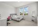 Serene bedroom featuring a comfortable bed, a bright window view, and a dedicated study area for a tranquil living space at 8023 Gore Creek Ln, Littleton, CO 80125