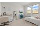 Bright bedroom with two windows, white walls, and a comfortable bed, complemented by a desk and modern decor at 8023 Gore Creek Ln, Littleton, CO 80125