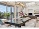Elegant dining area with contemporary chandelier and a view of the outdoor patio through large windows at 8023 Gore Creek Ln, Littleton, CO 80125