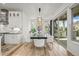 Elegant dining area featuring modern lighting, sleek furnishings, and access to an outdoor grill at 8023 Gore Creek Ln, Littleton, CO 80125