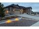 Beautiful exterior elevation of home with attractive landscaping and lighting at 8023 Gore Creek Ln, Littleton, CO 80125