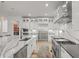 Contemporary kitchen with stainless steel appliances, island with seating, and waterfall countertops at 8023 Gore Creek Ln, Littleton, CO 80125