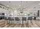 Bright open kitchen has large island with seating, stainless steel appliances and decorative pendant lights at 8023 Gore Creek Ln, Littleton, CO 80125