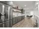 Modern kitchen featuring stainless steel appliances, sleek cabinetry, and an island with bar seating at 8023 Gore Creek Ln, Littleton, CO 80125