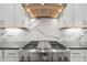 Modern kitchen with a high-end stove, designer backsplash, and ample counter space at 8023 Gore Creek Ln, Littleton, CO 80125