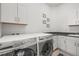 Functional laundry room featuring modern washer and dryer units with built in cabinets at 8023 Gore Creek Ln, Littleton, CO 80125