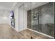 Bright living room features a fireplace, flatscreen television, and a glass-encased wine cellar at 8023 Gore Creek Ln, Littleton, CO 80125