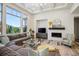 Bright living room featuring a large window, coffered ceiling, fireplace, and comfortable seating at 8023 Gore Creek Ln, Littleton, CO 80125