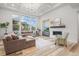 Bright living room features a fireplace, large windows, modern floors and recessed lighting at 8023 Gore Creek Ln, Littleton, CO 80125