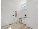Clean mudroom with white beadboard, bench with storage, hooks, and wood-look tile flooring at 8023 Gore Creek Ln, Littleton, CO 80125
