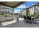 Beautiful covered outdoor kitchen with stainless steel grill and dining area perfect for entertaining at 8023 Gore Creek Ln, Littleton, CO 80125