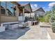Covered patio area with a fire pit and lounge seating, perfect for relaxing and entertaining at 8023 Gore Creek Ln, Littleton, CO 80125