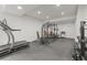 Fully equipped home workout room with treadmill, weights, and power rack, perfect for fitness enthusiasts at 8023 Gore Creek Ln, Littleton, CO 80125