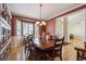 Formal dining room with hardwood floors, large window, and wood table at 8631 Gladiola Cir, Arvada, CO 80005