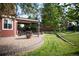 Brick patio with fire pit and seating area, next to the lawn at 8631 Gladiola Cir, Arvada, CO 80005