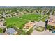 Aerial view of community park, highlighting playground, basketball court, and green areas amid homes at 13660 Monroe St, Thornton, CO 80602