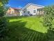 Beautifully kept backyard showcasing a lush green lawn, landscaping, and a seating area at 13660 Monroe St, Thornton, CO 80602