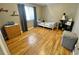 Bright bedroom with hardwood floors, playful decor, and a large window with natural light at 13660 Monroe St, Thornton, CO 80602
