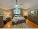 Cozy bedroom with hardwood floors, a ceiling fan, and ample natural light at 13660 Monroe St, Thornton, CO 80602