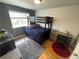 Bedroom with hardwood floors, a dark gray accent wall and a bunk bed at 13660 Monroe St, Thornton, CO 80602