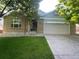 Charming brick home with a well-maintained lawn and attached two-car garage at 13660 Monroe St, Thornton, CO 80602