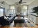 Spacious living room with vaulted ceilings, a ceiling fan, and a large sectional sofa at 13660 Monroe St, Thornton, CO 80602