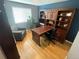 Office with hardwood floors, a built-in shelving unit and a large window at 13660 Monroe St, Thornton, CO 80602