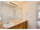 Bright bathroom featuring a double sink vanity with framed mirror and a decorative light fixture at 261 Hermosa St, Brighton, CO 80603