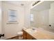 Well-lit bathroom featuring a vanity with a single sink, a large mirror, and a shower over bath at 261 Hermosa St, Brighton, CO 80603