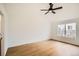 Bright bedroom featuring wood-look floors, a ceiling fan, and a window providing natural light at 261 Hermosa St, Brighton, CO 80603