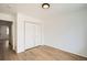 Bedroom with bi-fold closet doors and light hardwood floor at 261 Hermosa St, Brighton, CO 80603