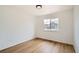 Bright bedroom featuring hardwood floors and a window offering natural light at 261 Hermosa St, Brighton, CO 80603